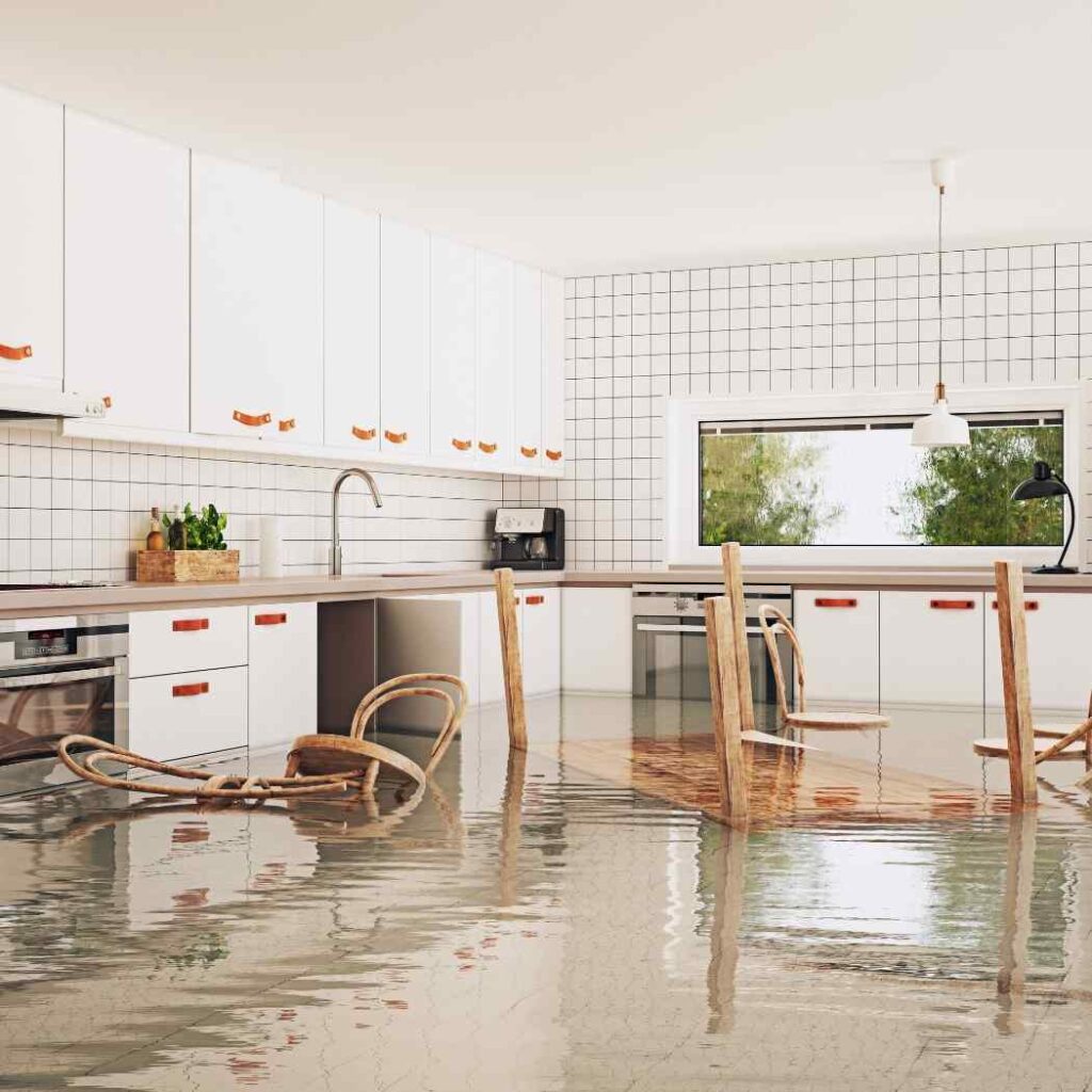 Flooded modern kitchen with water covering the floor.